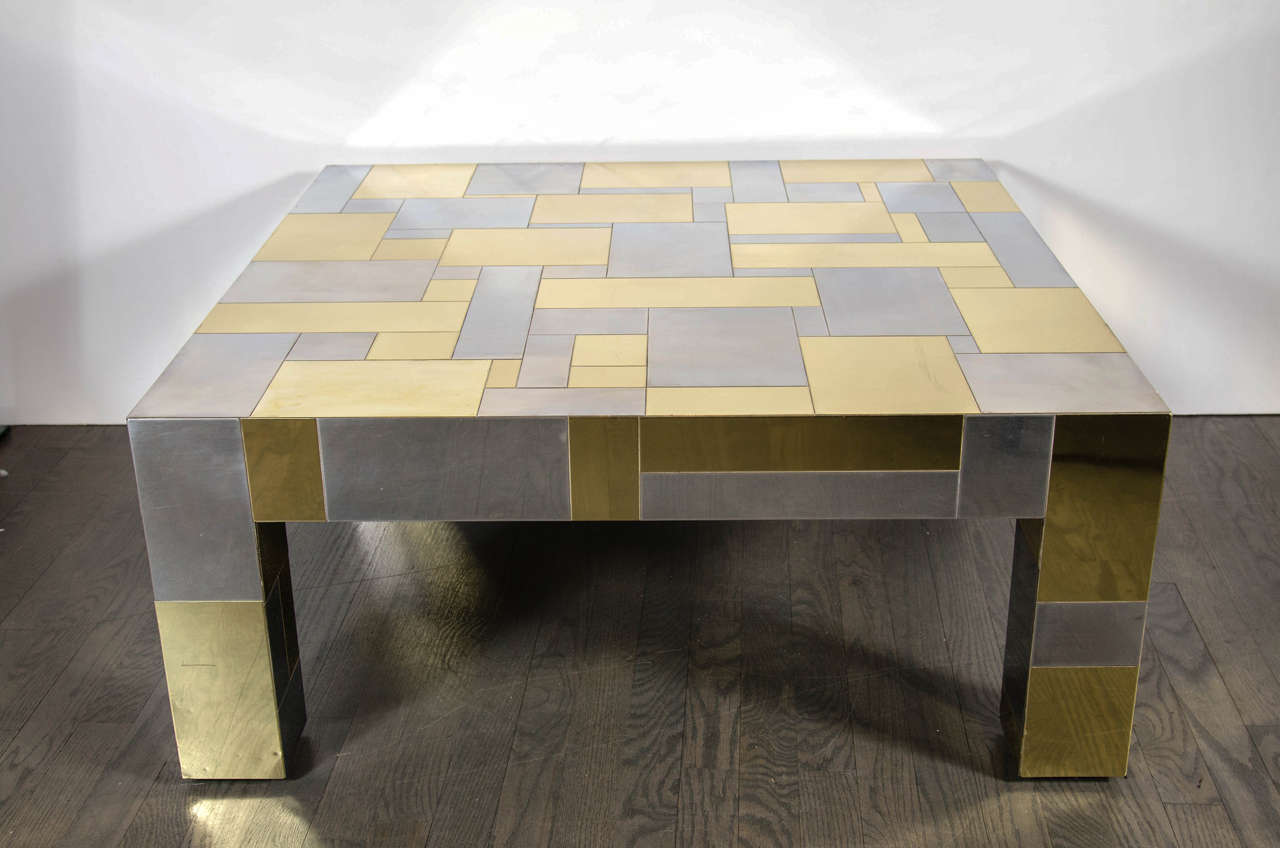 This gorgeous Mid-Century Modernist cocktail table by Paul Evans from his cityscape collection for Directional features a square design with a low profile; it has randomly arranged polished brass and nickel panels and carries the Paul Evans