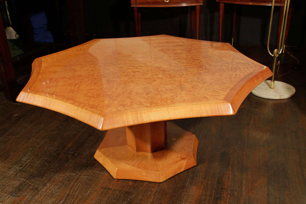 Octagonal cocktail table by Johan Tapp, of tiger maple and bird's-eye maple with convex sides and beveled edges. Octagonal base and fluted pedestal. A rare form by a highly regarded Mid-Century American furniture maker.