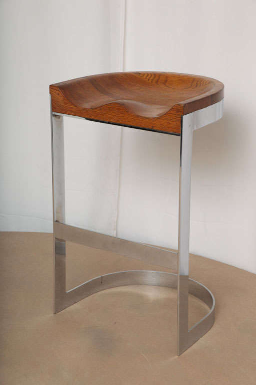 Rare and distinctive bar stool with a chromed metal base and carved oak seat