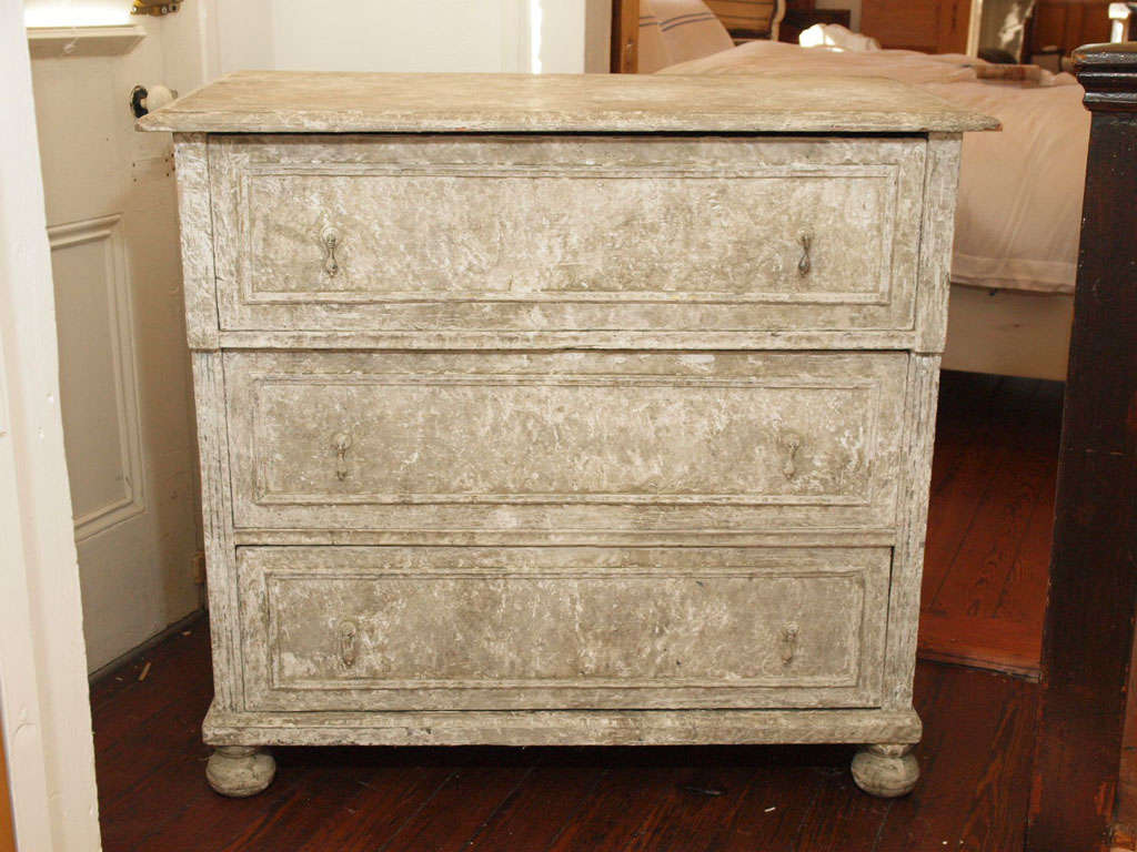 Antique painted 3 drawer swedish commode with ball feet and drop pulls.  Beautiful layers of paint.