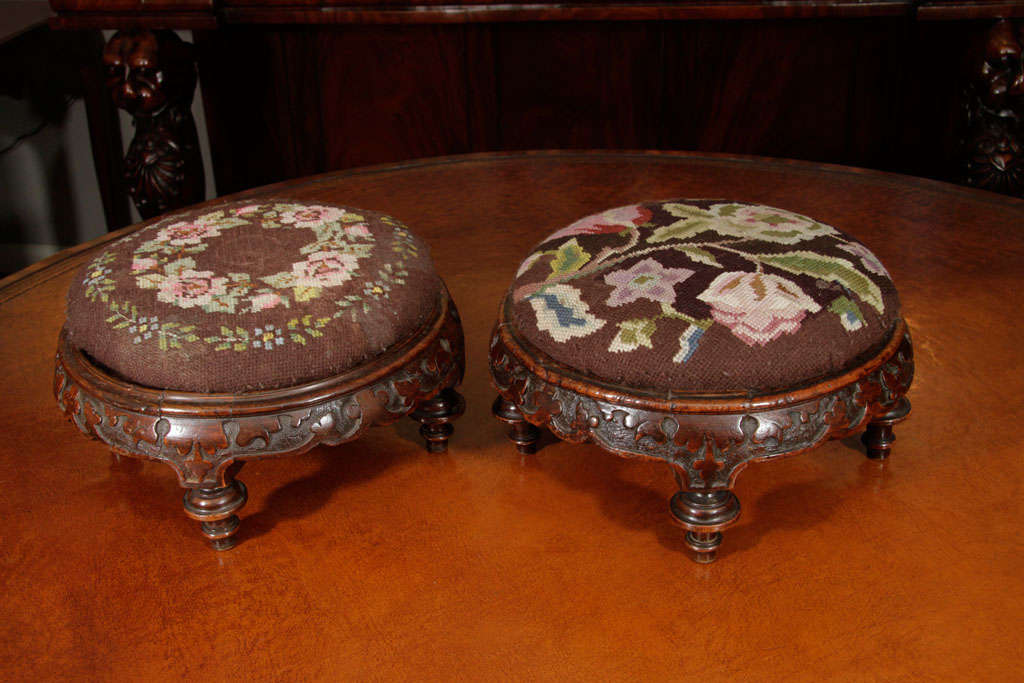 Pair of Irish mahogany gout stools of circular form, the frieze embellished with carved shamrocks raised on turned feet.