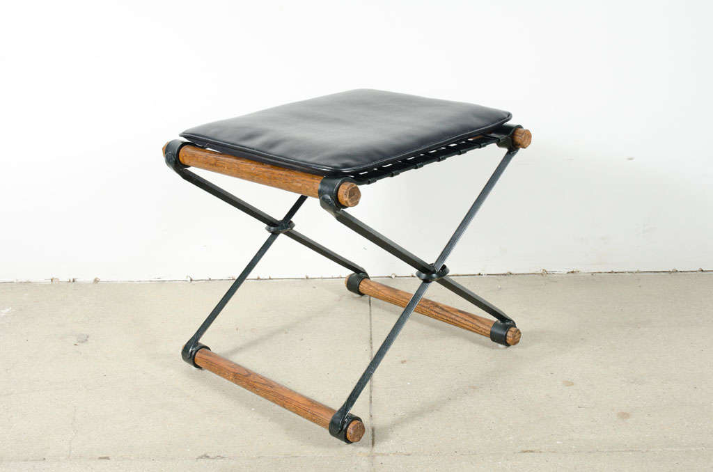 A pair of wrought iron and oak X fame stools with loose seat cushion in the casual tradition by Californian Cleo Baldon for Terra Furniture. American, circa 1970.