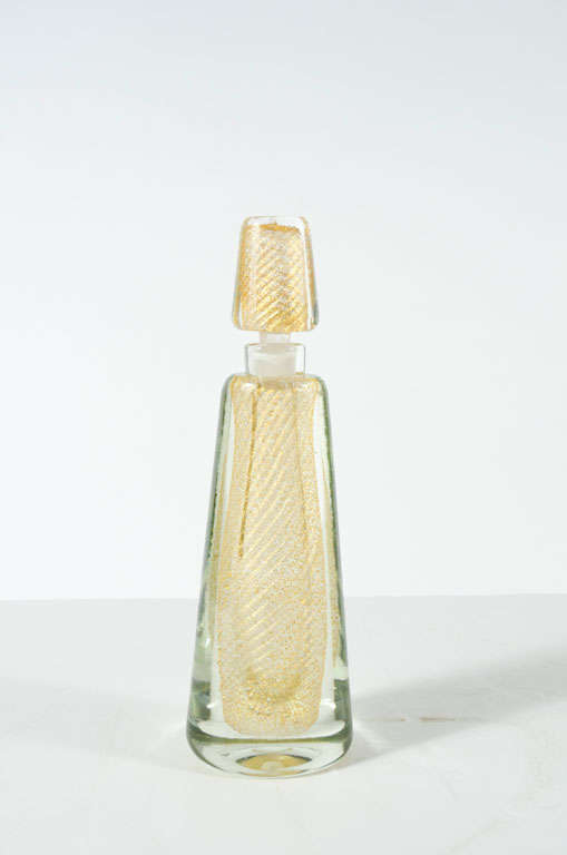 A beautiful perfume bottle and stopper in clear hand blown glass with sommerso gold leaf inclusions in a swirl pattern.  Paper label to base: 