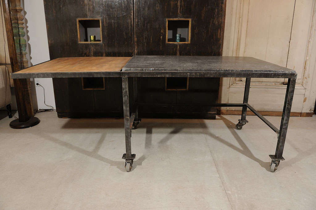 Belgian chocolatiers table on metal rolling base . 

Dual purpose top / sycamore and bluestone