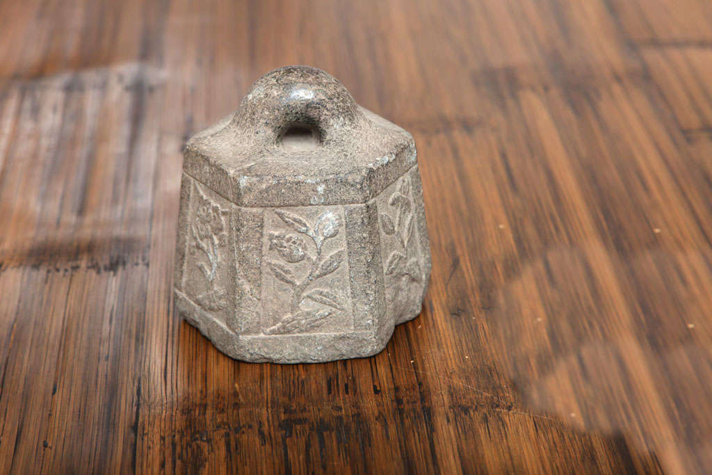 nicely carved stone weight for a scale, probably used in a marketplace. granite .