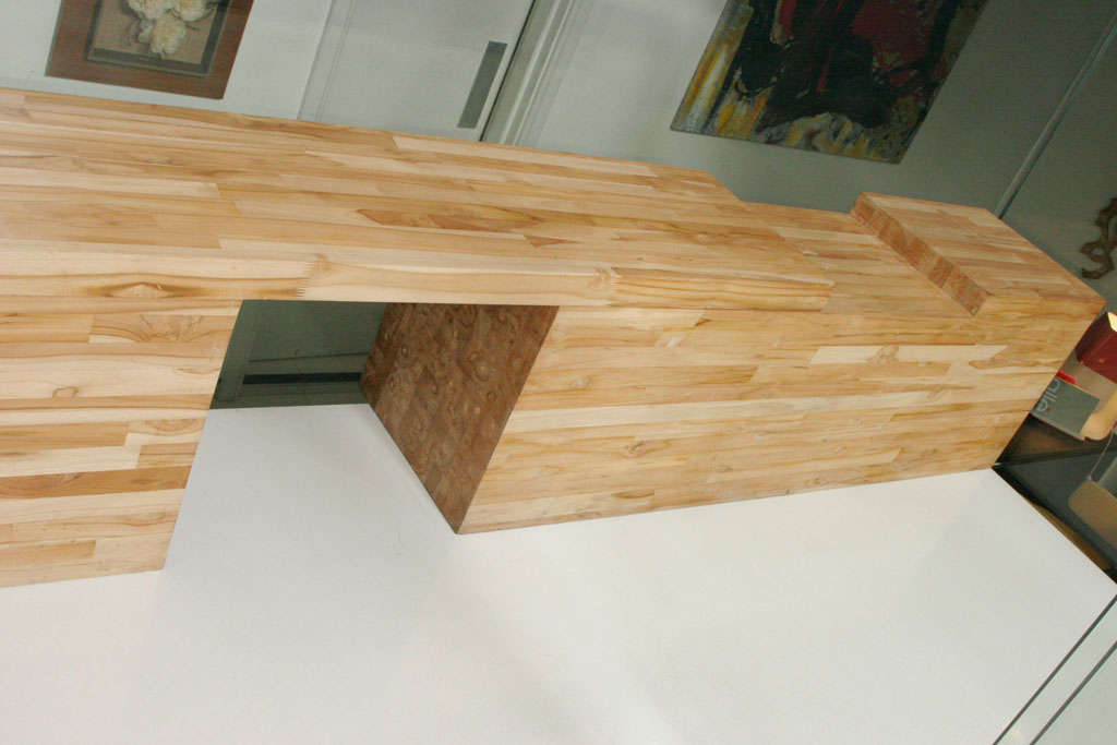Solid wood extendable bench by Brazilian designer Leonardo Bueno.