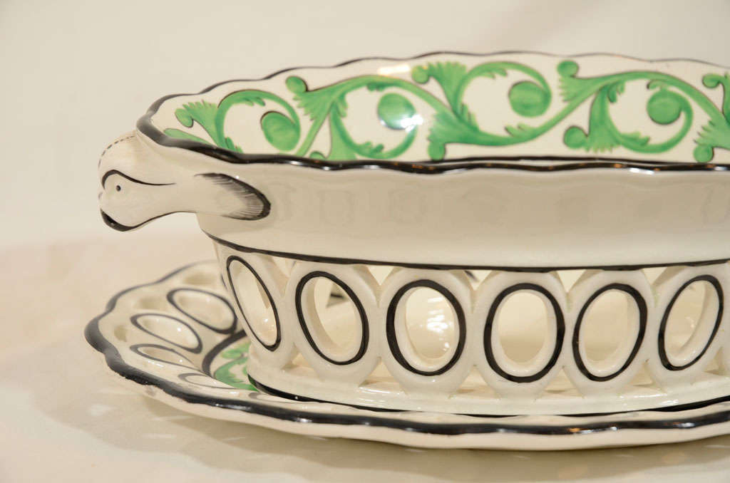 A pair of Spode pierced Creamware baskets and stands with an apple green scrolling vine design and black edging on both the baskets and stands. The baskets have dolphin head handles.