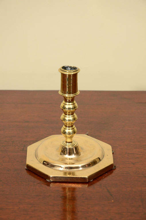 Single Dutch brass candlestick with turned center on octagonal base