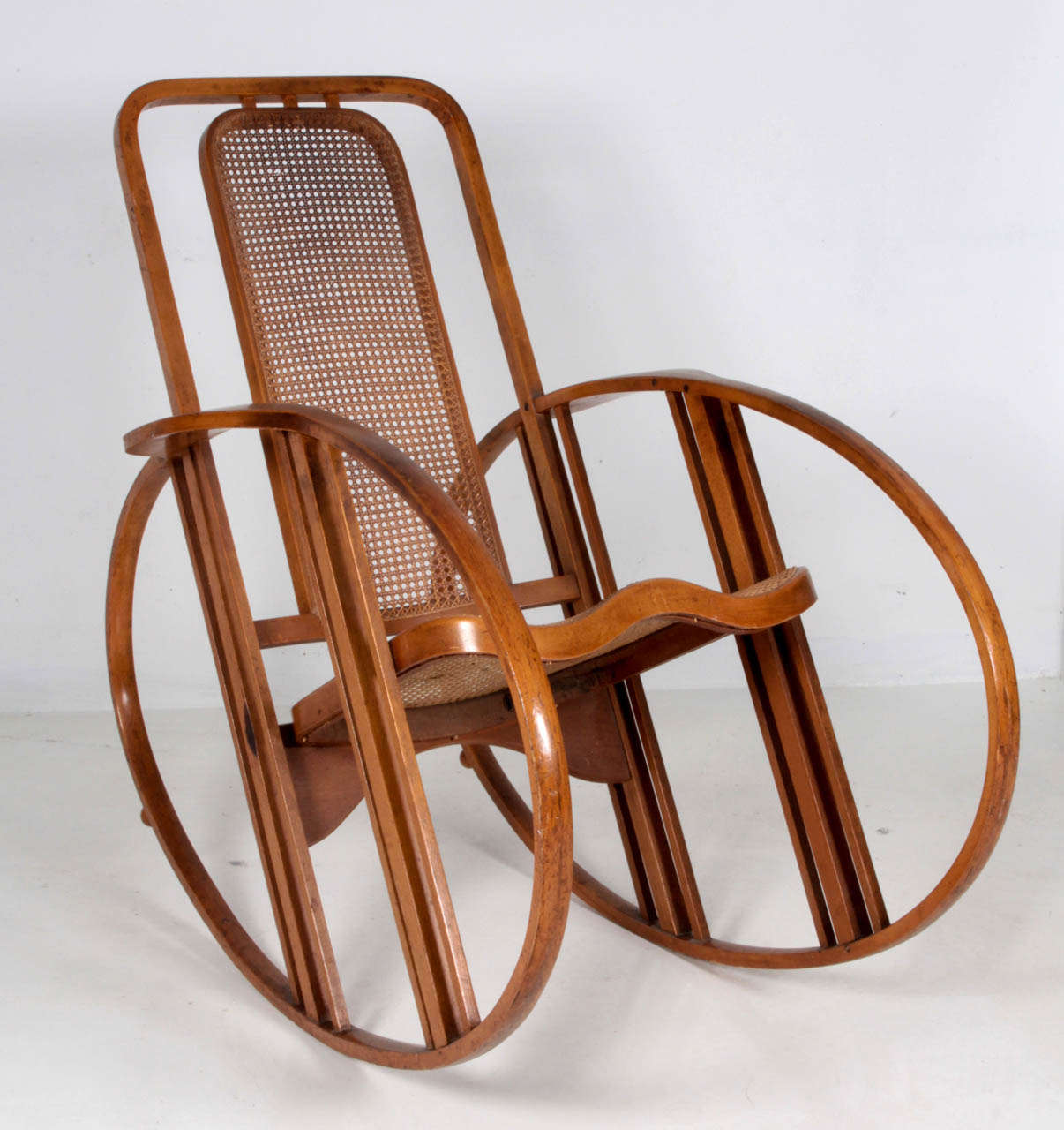Antonio Volpe, Italy
Josef Hoffmann (attr.)  (1870-1956),  Austria    
Società Anonima, Udine

“Egg” rocking chair, circa 1920.

Steam bent beech with a natural patina, original caned seat  and back, Model No. 267

Marks: branded logo