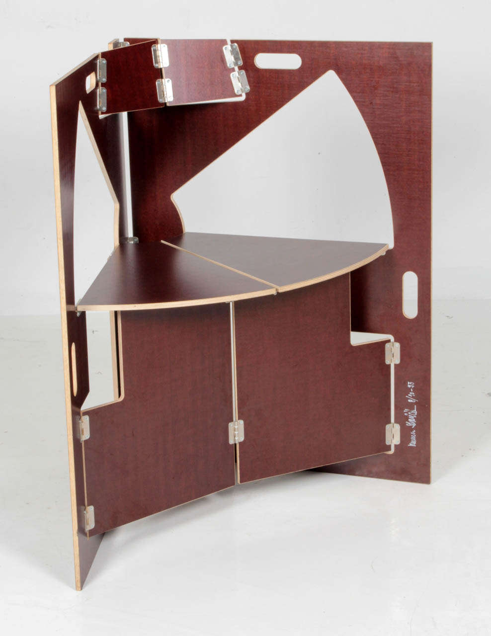 Werner Schmidt (b. 1953)  Switzerland.
 
Folding triangle chair, 1993.

Dark brown laminate Plywood, hinges. 

Signed:  Werner Schmidt, 8/10, ‘93 (script signature in white permanent marker)

For related folding table by Schmidt see