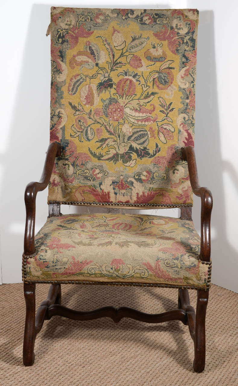 This lovely French armchair will add old world charm to any room in your home. It still has its' original tapestry on the seat and inside back. The textile is missing off of the outside back, but you can see where it was originally stuffed with