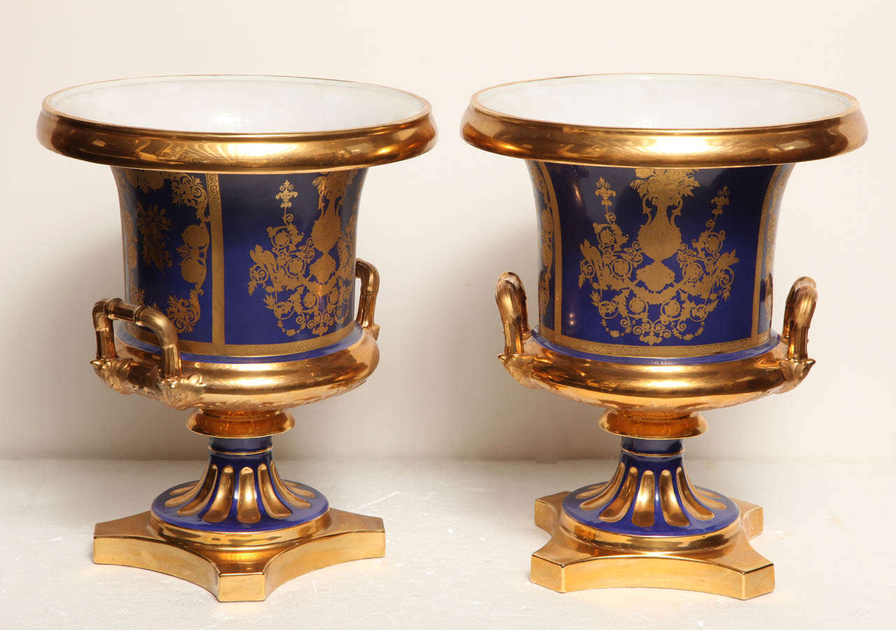 Pair of French, Blue Ground, Gilded Neo- Classical Urns