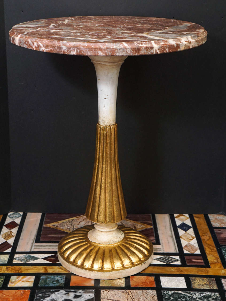 This small low table designed as a smoking or cocktail table would look great in a modern simple room or in an antique style room . Made from carved wood which has been gessoed and then painted and gilded. The tables gilding is rich and in excellent