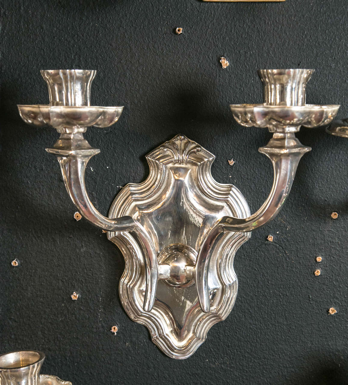 Pair of circa 1920s silver plated Caldwell sconces. Twelve available, priced per pair. Newly wired upon purchase.