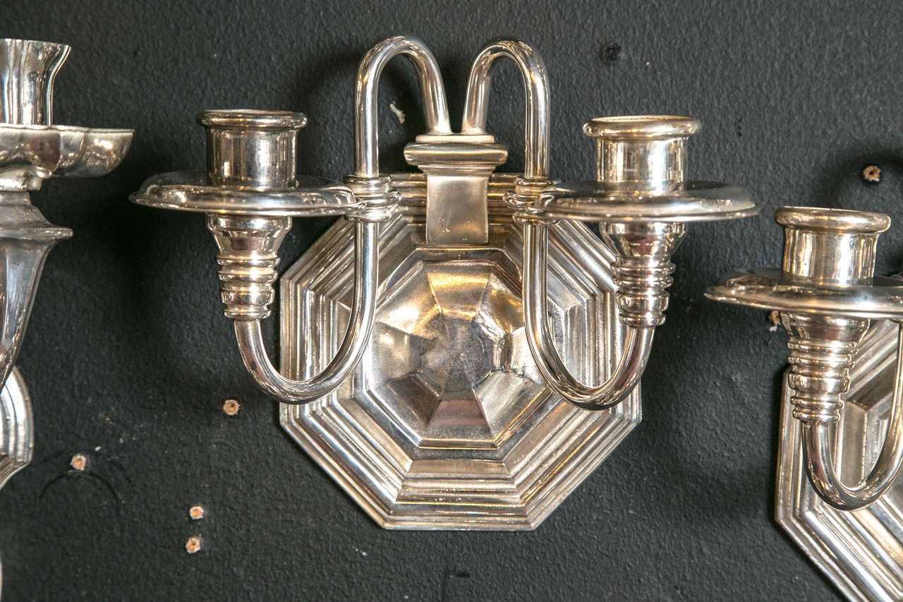 A beautiful pair of silver plated Caldwell sconces. Twelve available, priced per pair. Newly wired upon purchase.