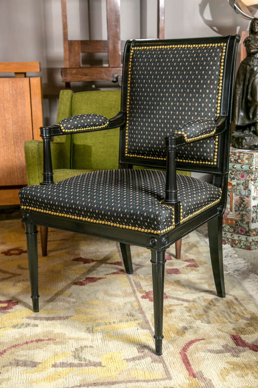 A French director style ebonized armchair. Completely restored and reupholstered. c. 1940's.