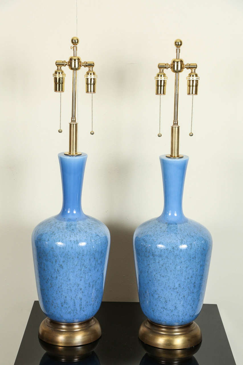 This large pair of ceramic lamps have  a wonderful blue glaze finish.
The lamps are mounted on brass bases and they have been newly rewired with 
polished brass double clusters. 
The height of just the ceramic is 22.5
