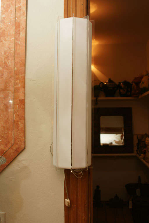 Long white and clear Lucite strip sconce. Option of hanging vertically or horizontally.