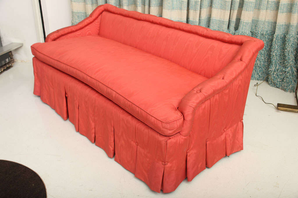 SYRIE MAUGHAM (1879-1955)<br />
Settee with low back upholstered with button tufting <br />
and kickpleat details in rose moiré taffeta. <br />
English, c. 1950.<br />
<br />
PROVENANCE<br />
From Highwinds, residence of Leila and Dewitt