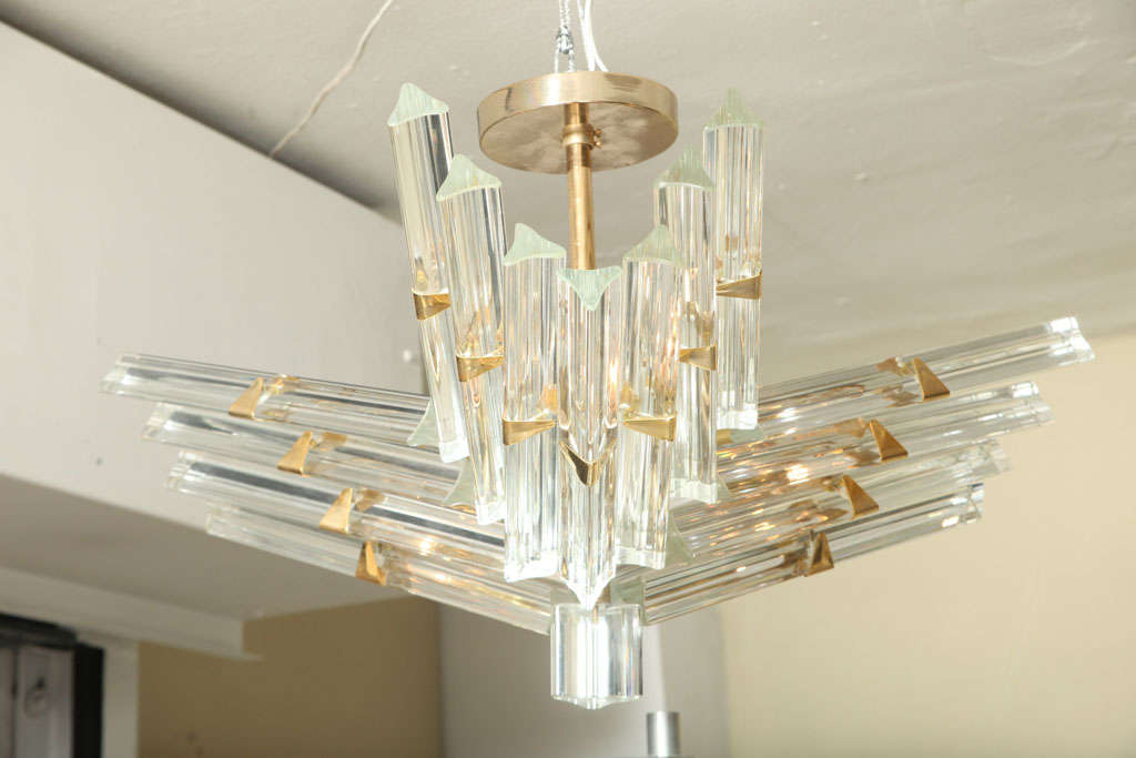 This sculptural form flush mount ceiling fixture, produced circa 1960s, includes Venini 'triedri' crystal glass prisms, with brass mounts.