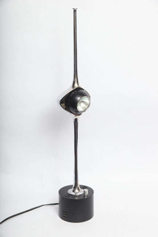 A sculptural cobra table lamp with adjustable eyeball.
