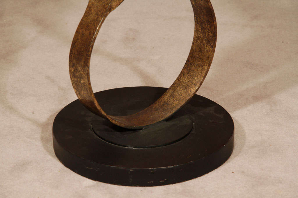 A lyrical metal sculpture depicts a dancing couple blended into ribbons while moving as one to an accelerated rhythm. This enegetic, imaginative work is mounted on a black iron base.

Reduced from $2200.00