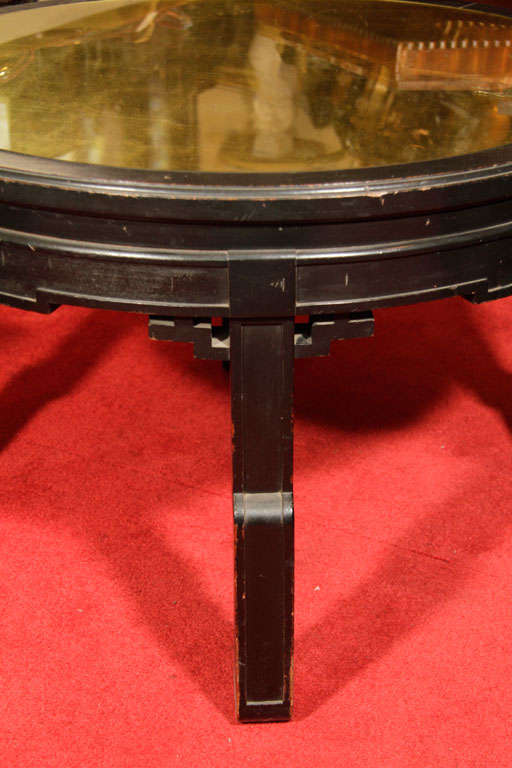 Black lacquered Chinese inspired table with gold leaf eglomise under inset glass.

3790
