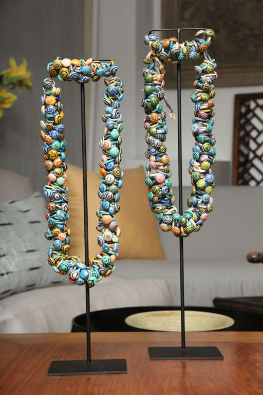 A decorative necklace from Mali consisting of brightly colored rings of rubber strung on a cloth cord.  30