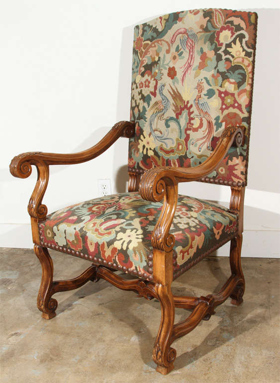 Hand-carved, French, walnut armchair with scrolling wood work and original, petit point fabric.