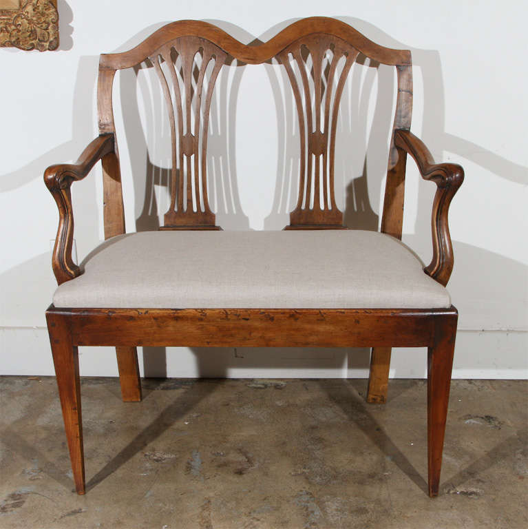 Pair of Tuscan, walnut, two-seat settees from Florence, Italy.