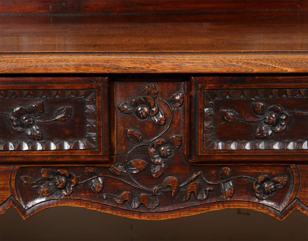Hand-carved, southern French, two-drawer bench with serpentine back and floral reliefs.