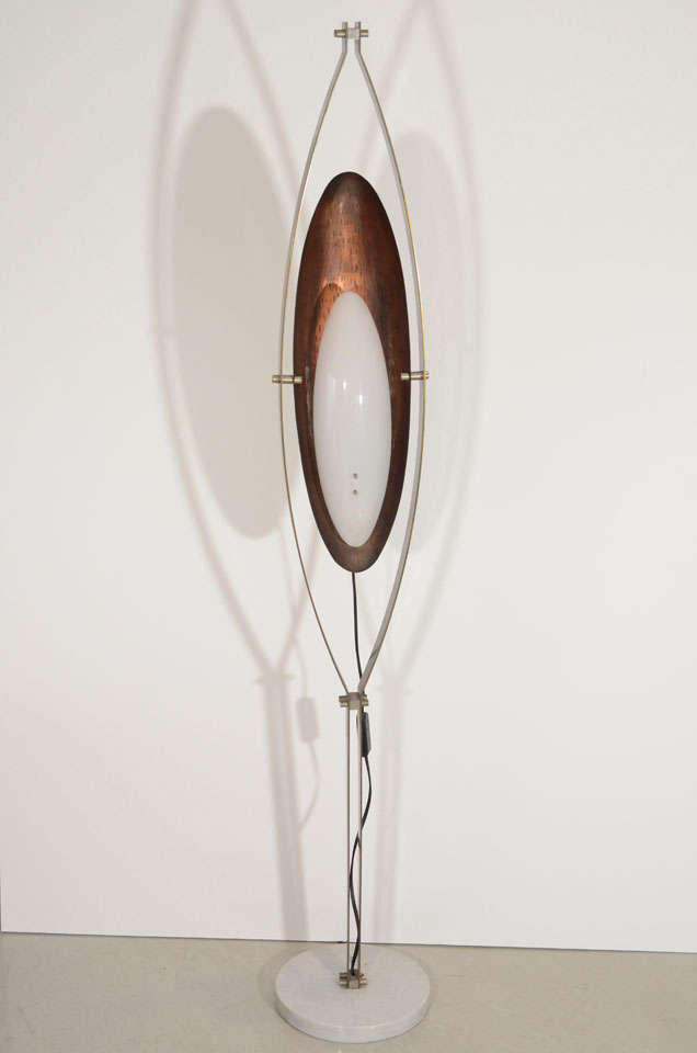 A hammered copper back shade and a perspex globe highlight this unusual floor lamp. A silver metal frame on a white marble base complete the designer's look. This lamp has it's original perspex globe and is completely rewired for a maximum 25 watt