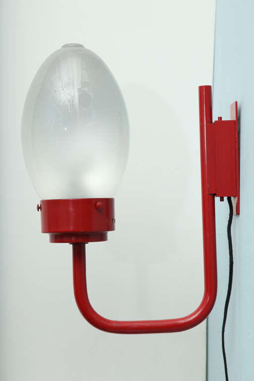 Playful wall sconce with painted, ovoid glass diffusser. Metal structure in original bright red enamel paint.
