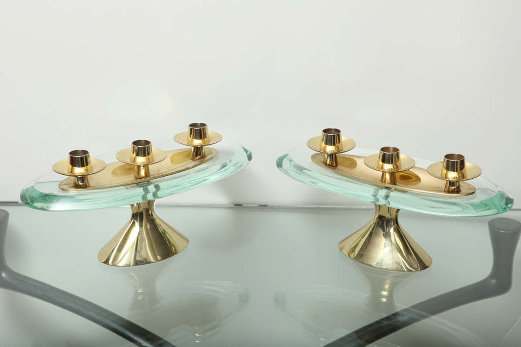 Very beautiful pair of candelabra, of polished brass elements with thick crystal slabs. A very rare form, with stamped signatures to the metal.