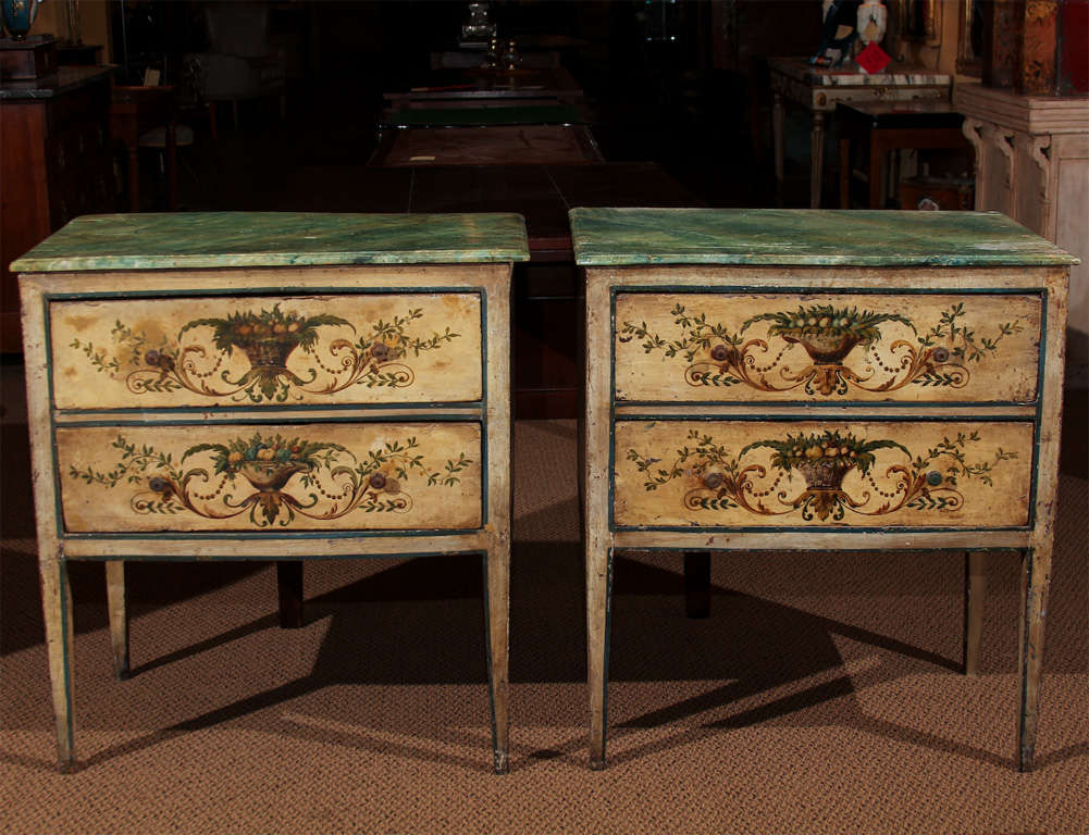 Pair of Italian 18th Century Painted Commodes

This a very rare pair of two-drawer commodes or chests.  

They feature faux marble tops (wood painted tops). The chests themselves are beautifully painted with the original paint with the