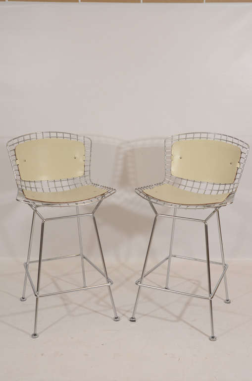 Pair of Bar Stools by Harry Bertoia for Knoll. This variation is rare with a satin chrome finish and leather hides for pads.  Please contact for location.