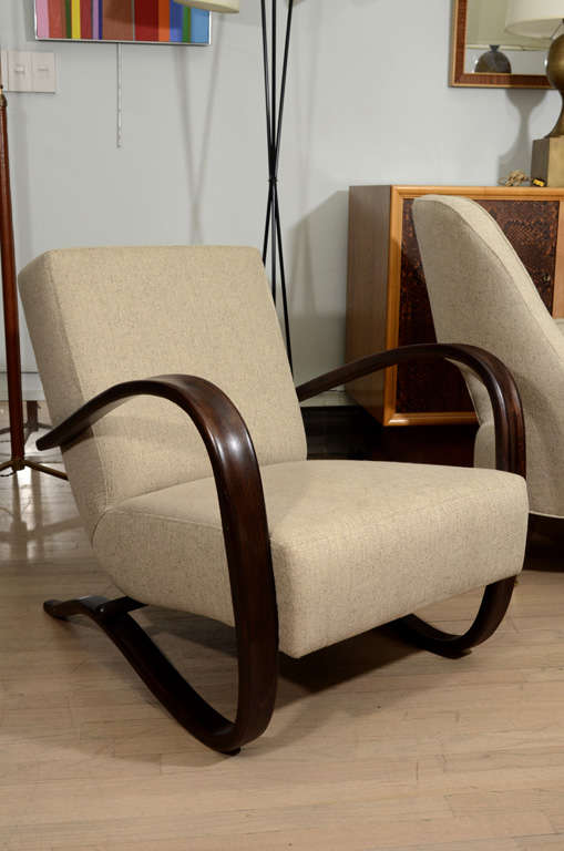 Pair of lounge chairs by Czech designer Jindrich Halabala, circa 1940s. Chairs have curvy sculpted wood frames. Seats are 15