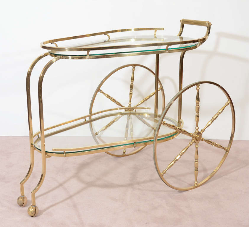 A vintage serving cart in polished brass with two clear glass shelves.

Price reduced from $2450.00