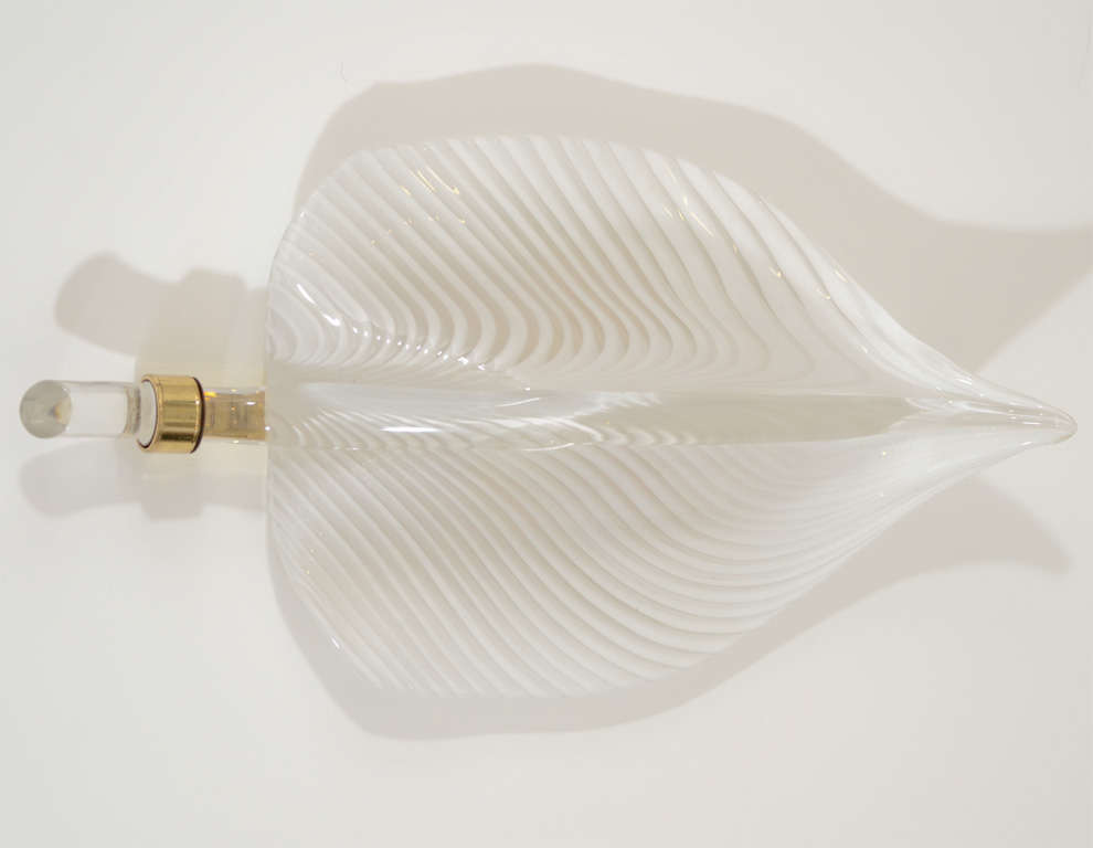 Fabulous white and clear Murano glass wall lights in the shape of leaves with brass detailing by Venini.We have two Pairs available,the price listed is for each pair.