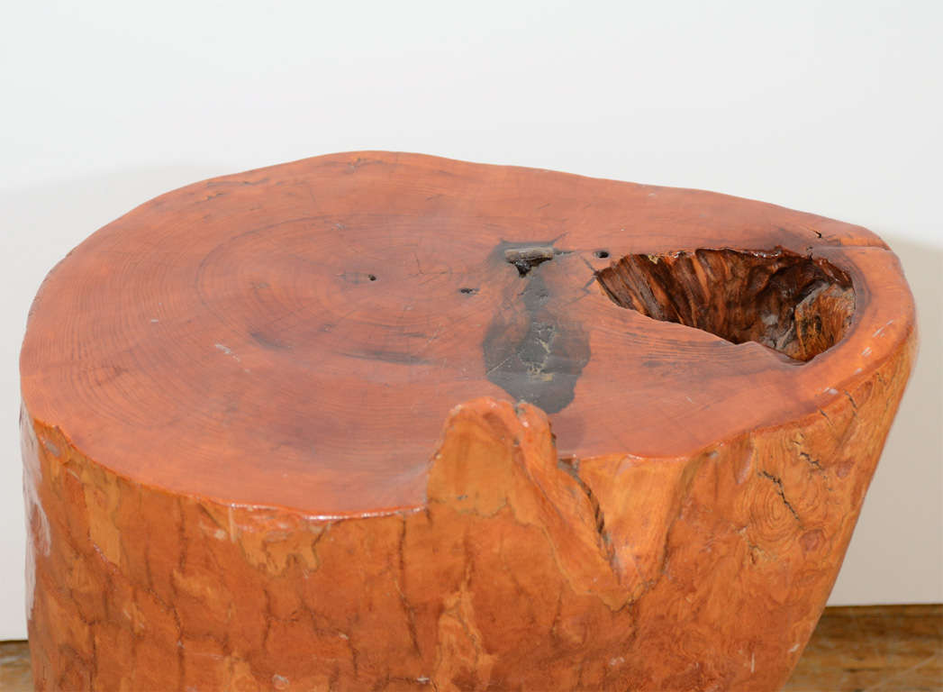 A live edge tree trunk end table with a glossy lacquered finish and a natural hole in the surface.

Price reduced from $1400.00