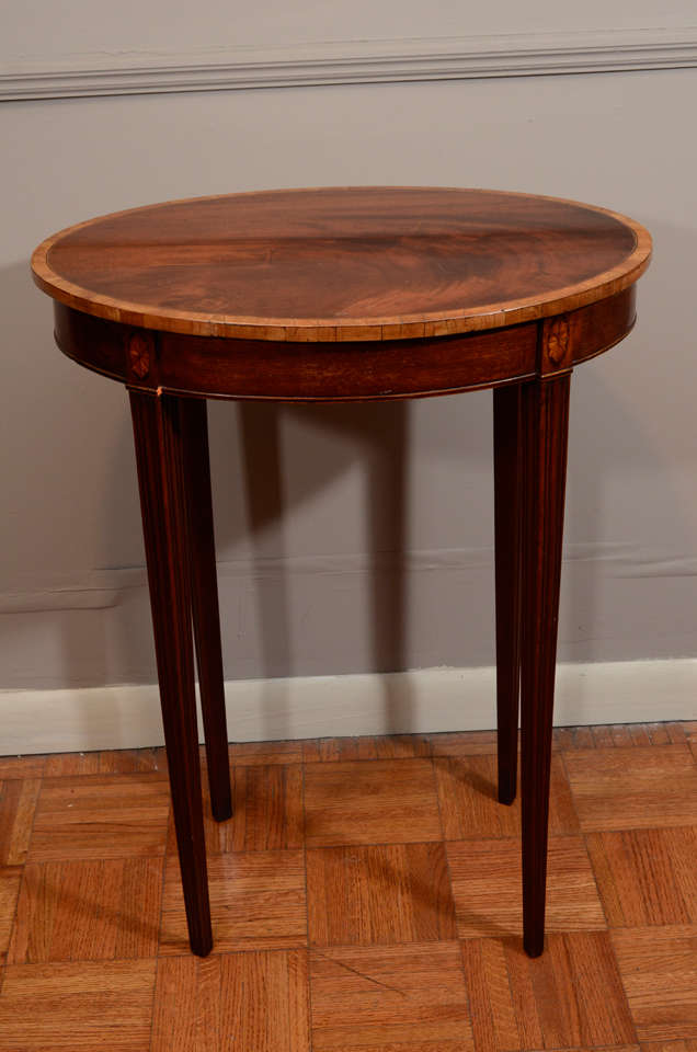 Pair of Oval Georgian Mahogany End Tables on Fluted Tapering Legs.