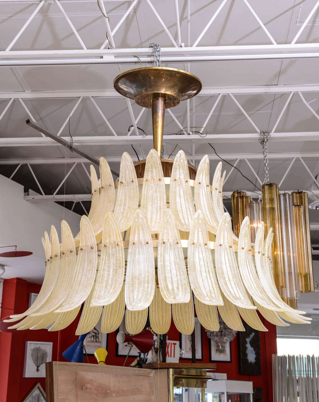 Splendid chandelier consisting of a brass frame draped with handmade Murano glass palm leaves in scavo texture.