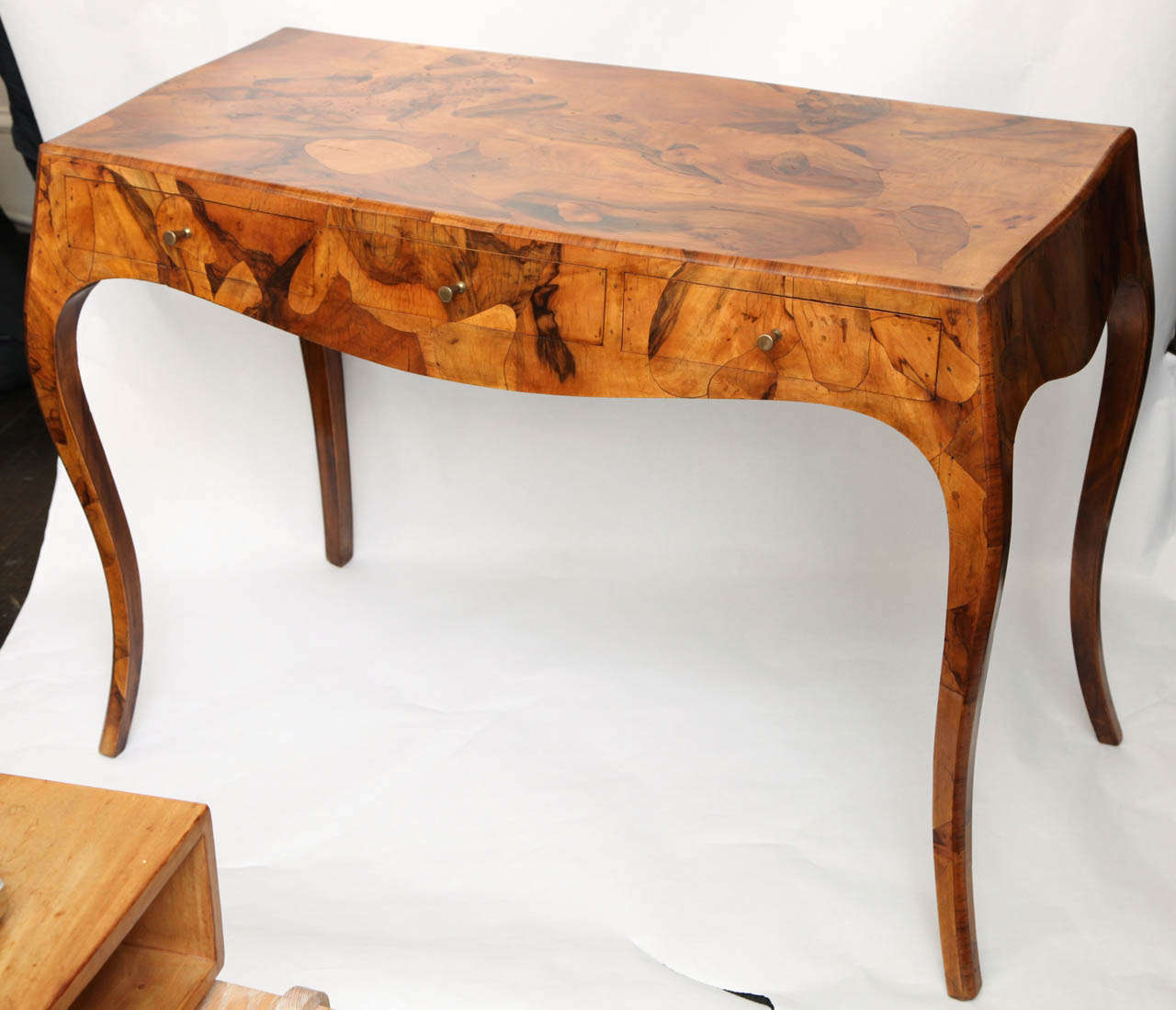 An Italian Art Moderne console/desk of exotic woods.