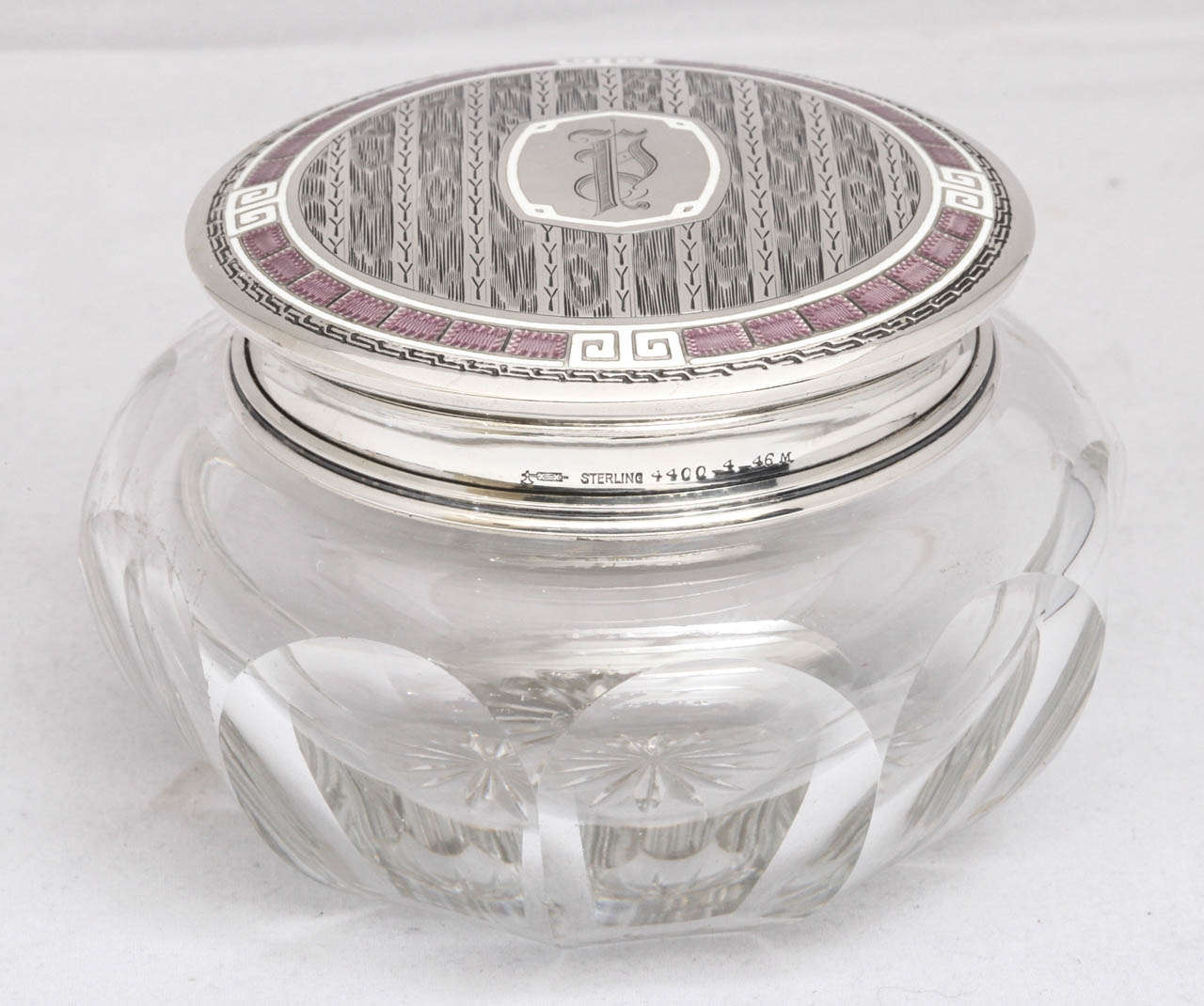 Unusual, Art Deco, panel cut crystal powder jar mounted by a sterling silver and light purple and white guilloche enamel lid, William B. Kerr & Co., New Jersey, Ca. 1920's - 1930's. Light purple guilloche enamel is bordered by white guilloche