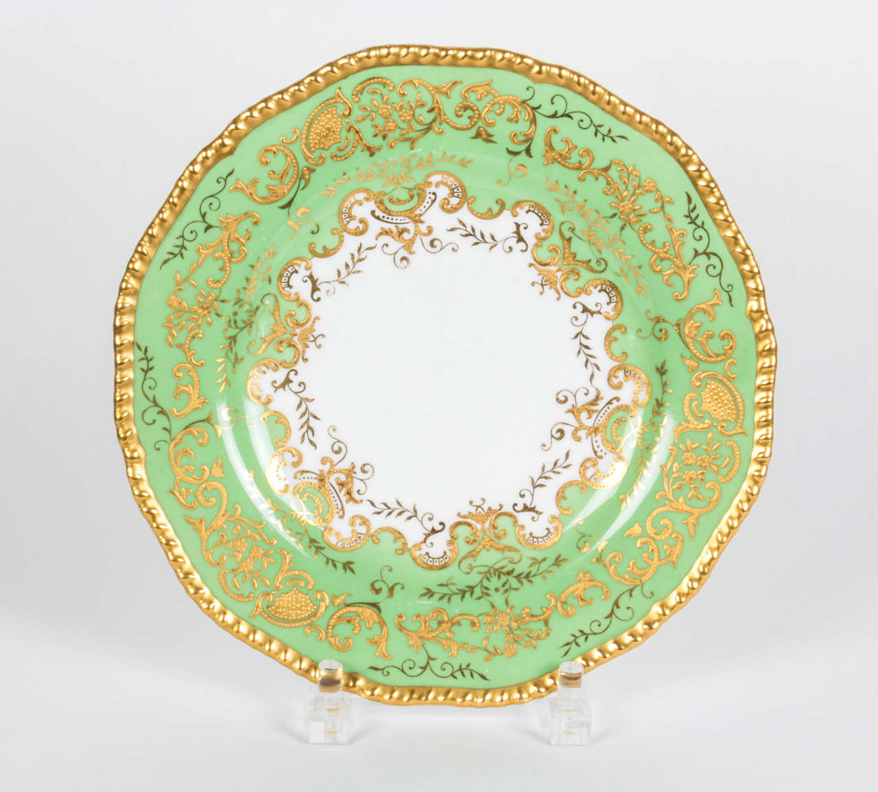 Tiffany & Co. green dinner plates with raised gold gilt detail. Classic Coalport England gadroon shape custom ordered. Additional gilt foliage design on inner collar. Circa 1905