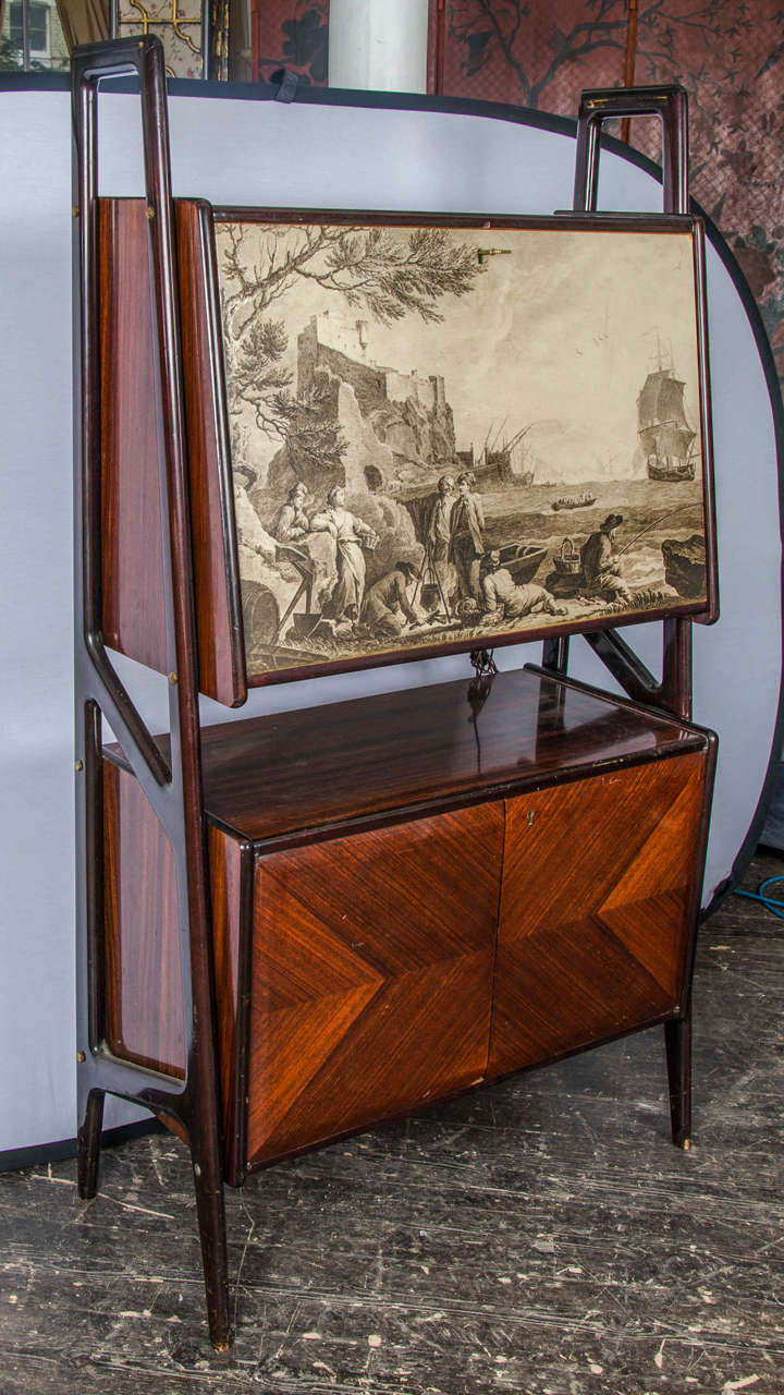 Very decorative and unusual bar or cabinet in mahogany with classical landscape with figures on the front door.