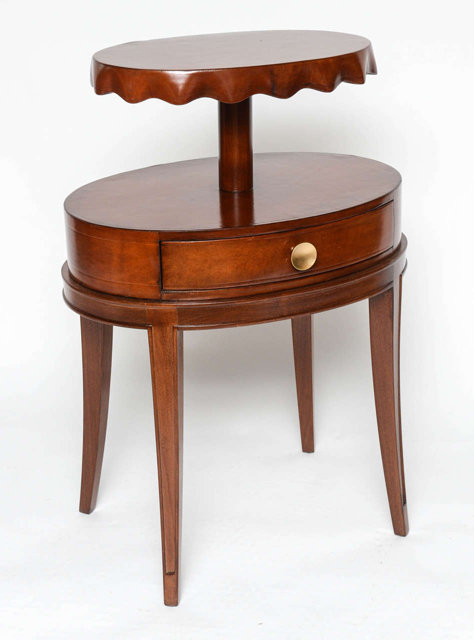 In draped fabric style, this chocolate-brown leather table is two-tiered and a single drawer. Beautiful!