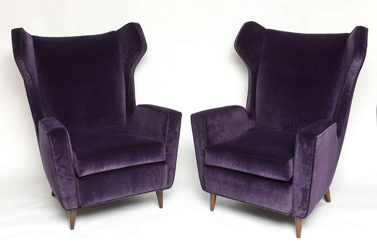 Luxurious velvet winged armchairs fully refurbished.