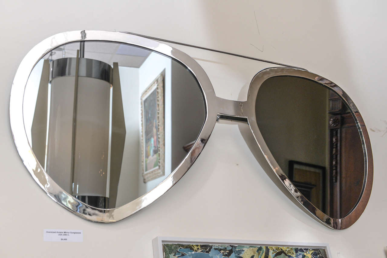 Finished in polished chrome frame, these oversized aviator glasses wall mirror are a fun and practical accent to your decor.