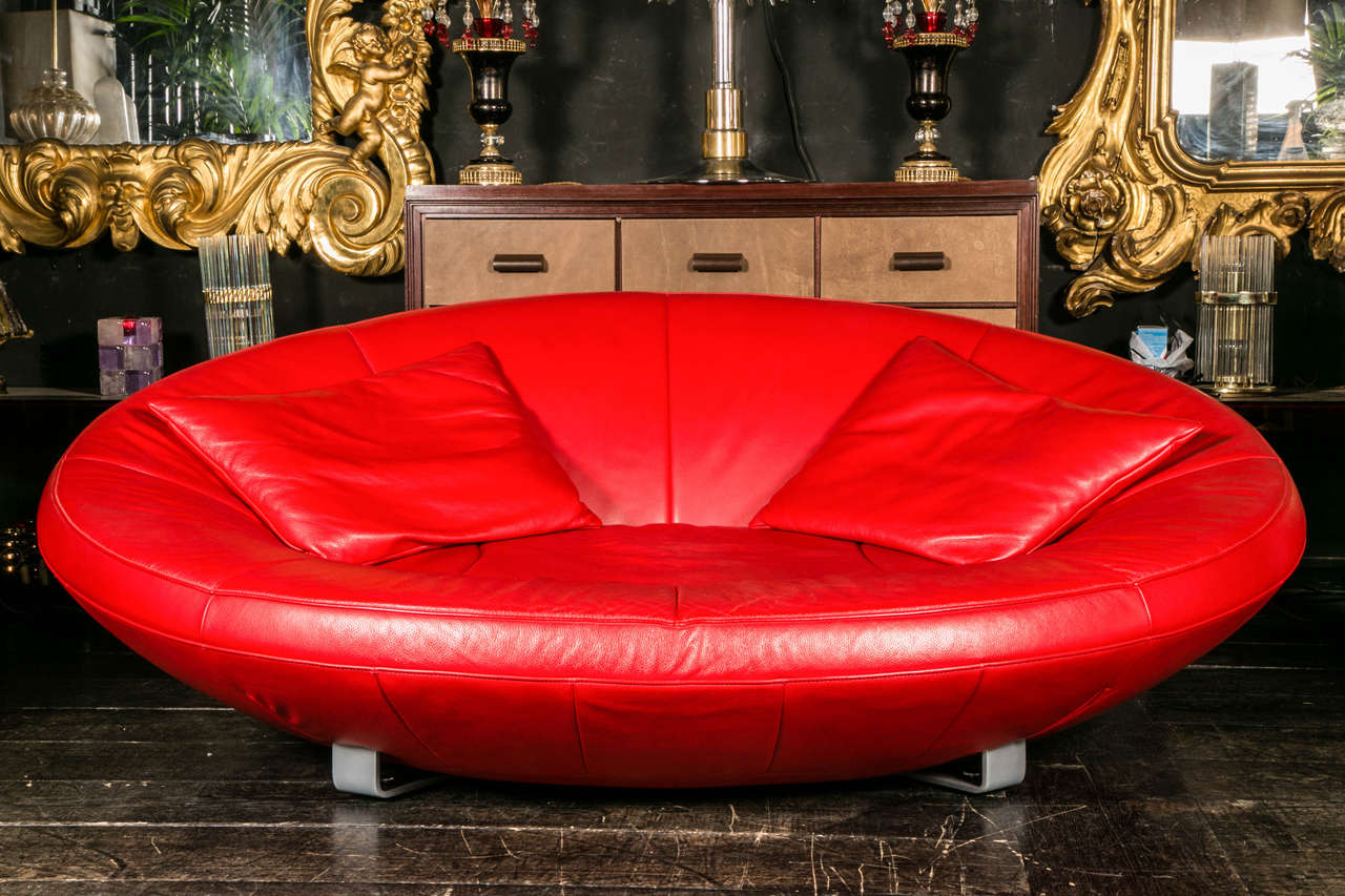 Sofa , 1980's, by De Sede, in red leather, with two cushins,